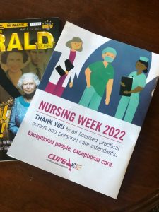 Photo of front and back cover of the NL Herald magazine, with a Nursing Week ad by CUPE NL